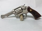 Firearm, Revolver, Ser:2157667, wood grips/nickel finish, Mfg:Taurus Firearms, Finish:Nickel, Action:Double, Cal:.38 Special, Mod:80, Cond:Used, Importer:Taurus Int. Mfg. Miami, Fla.