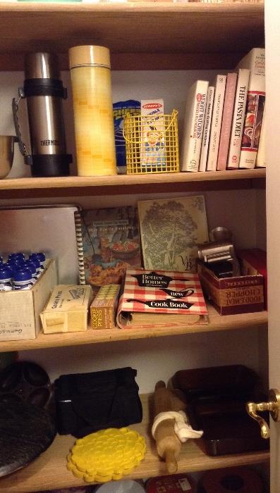 Kitchen items including Thermoses, cookbooks, cookie presses, Universal meat chopper in original box, rolling pin & more