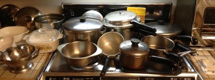 Pots & pans including Revere Ware, Corning Ware, Calphalon non-stick square griddle, Mirro-matic pressure cooker, stainless bowl set, colander & more