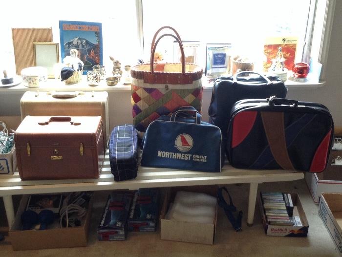 Vintage luggage & tote bags - sitting on a 5 ft. long white slat bench (needs repair). Also hand & ankle weights, a few cassettes 