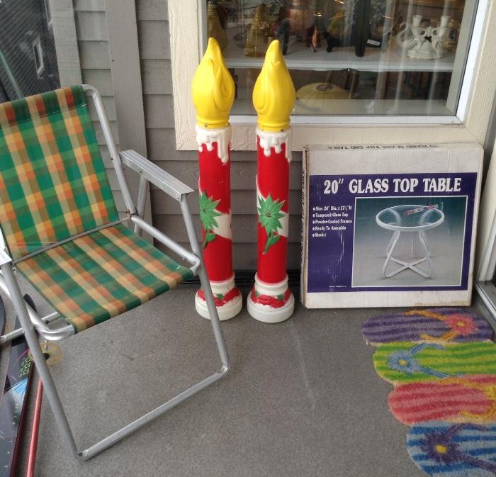One of a pair of aluminum folding chairs, plastic Xmas yard candles, glass top patio table (new in box).  NOTE: Colorful door mat is not for sale.