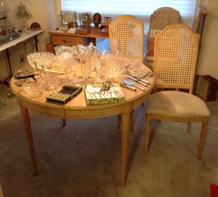 42" round "bamboo motif" dining table + 4 cane back dining chairs - table has an 18" leaf that extends table to 60" long oval