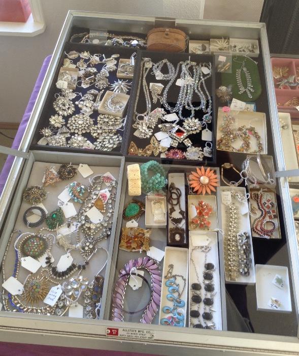 This is just a portion of the TONS of vintage costume jewelry - we have 2 big cases FULL!  Plus 2 tables full of non-case jewelry.  LOTS of rhinestones (some Eisenberg), Trifari & other signed pieces, real pearls, Mexican sterling, Biliken tie tack, sterling charm bracelets & chains, Austrian crystal necklaces, Siam sterling pieces, real & faux pearls, lots of necklaces, bracelets, brooches & earrings, many ski pins & so much more...