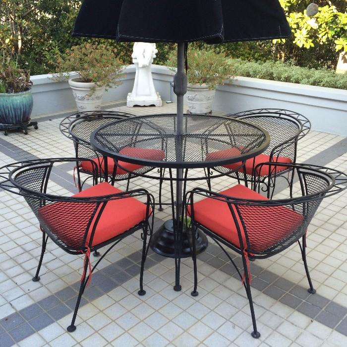 Woodard Wrought Iron Patio table, 4 Chairs and a black umbrella 