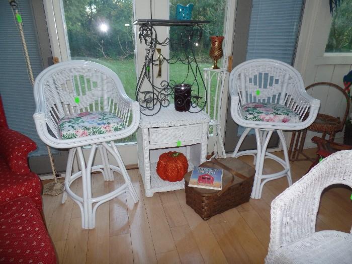 Two wicker swivel tall chairs, wicker night stand, picnic basket, and wrought iron table w/tile top