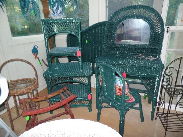 Green wicker furniture with twin head board, two night stands and vanity with chair. 
