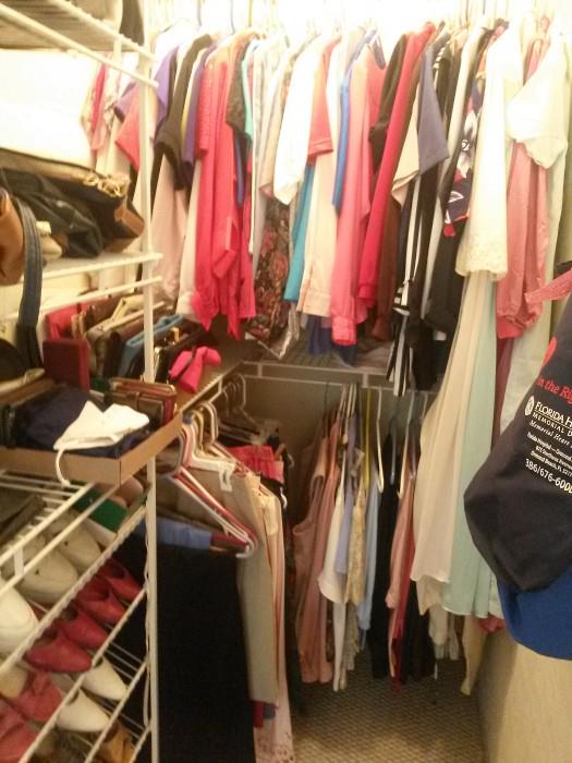 3 closets and 6ft. table filled with women's clothing