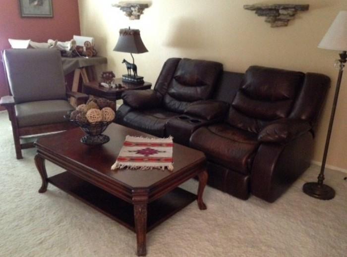Ashley dual-reclining love seat with console, Craftsman/Mission-style chair on the left. Coffee table matches the end table in the background and a sofa table 