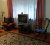 television and stand, rocking chair, rug