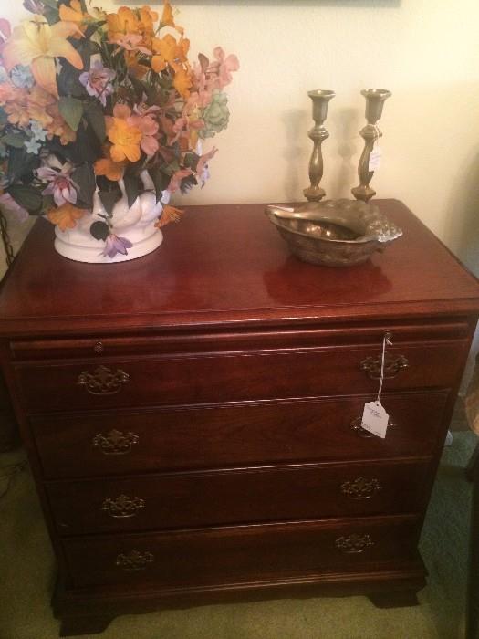 Four drawer chest; floral arrangement; brass items