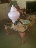 Brass top end table; white stoneware urn