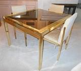 Mirrored brass frame with smoke glass top dining table. Swaim Designs from Macy's. View shows table extensions condensed to seat four