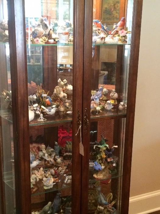 Curio cabinet filled with birds