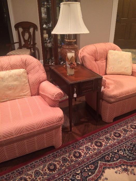 Matching peach-colored chairs; one of two matching side tables and lamps