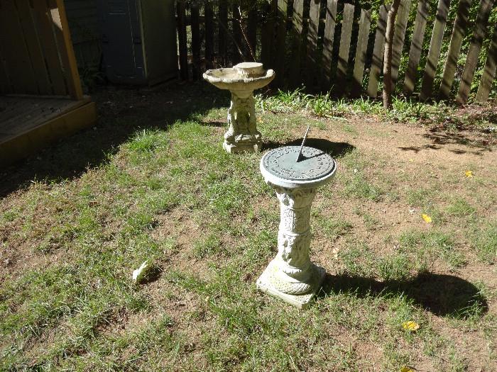 Cement bird bath and sundial.