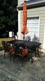 Somber looking wrought iron table and chairs, but you should see it when the umbrella is at full attention!              O M G !