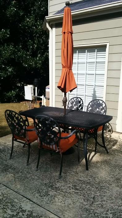 Somber looking wrought iron table and chairs, but you should see it when the umbrella is at full attention! O M G !