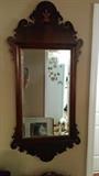 Nice repro mirror with all the trimmings - inlaid wood fleur de lis at top, lot's o' curlicues top and bottom, with a pretty beveled mirror reflecting the cutest Cavalier King Charles Spaniel you'll ever see!
