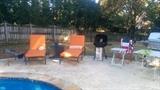 Aww! Summer's last hurrah - a nice gas grill, chaise lounges, barbeque grill, red/white/blue folding chairs.