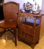 Wood & woven wicker side chair. Rattan display bookcase. Wood sailboats on top of the bookshelf. 