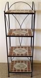 Display stand with black metal frame and tile shelves