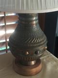 One of a pair of artistic copper lamps