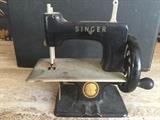 Mid Century child's toy working vintage Singer sewing machine.