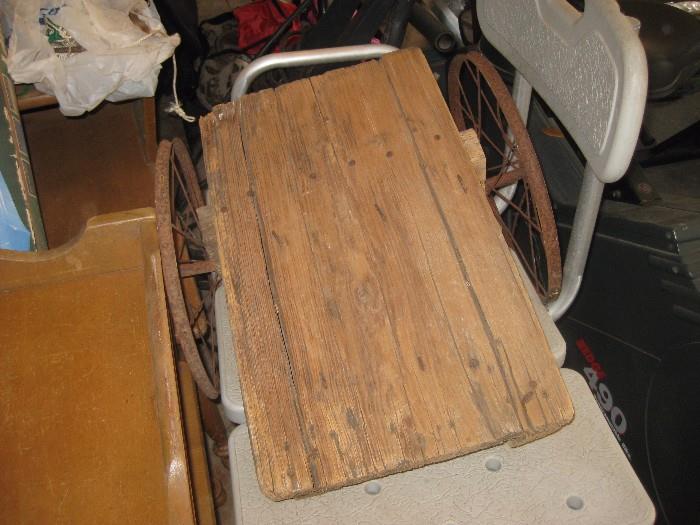 old wooden pull cart with metal wheels