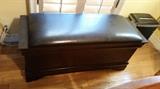 A nice leather-topped storage bench.