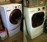 A front-loading washer and dryer, with storage drawers under each.