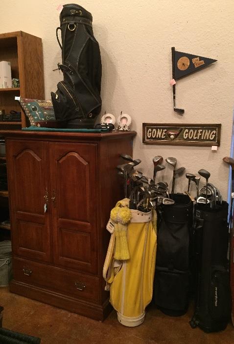 Small armoire and golf clubs.