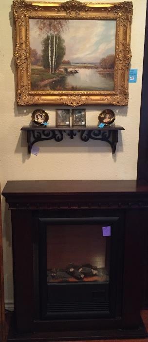 Electric fireplace and oil painting.