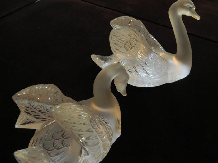 Lalique Crystal Swan Down Figure Clear crystal. DiMen'sions: H 7.09" x L 14.17" x W 8.27" (H 18 cm x L 36 cm x l 21 cm). Weight: 21.16 lbs (9,60 kg). Handcrafted in France. Designed by René Lalique, 1943. 
