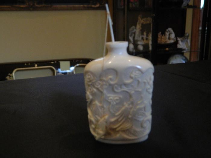 Hand carved Ivory Colored small Asian bottle  Measures 1 1/2 inches wide x 2 1/2 inches tall Item 0120