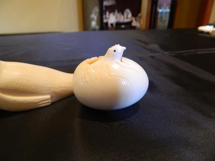 Very intricate Ivory Colored hand carved egg with emerging chic  Egg measures 2 inches x 2 inches item 0123 