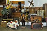 Various Antiques & vintage items. From England, USA, among others. Gossip bench, raggedy Ann rocking toy, Iron and brass candle sticks, statues, wicker, plants, bird cage, underwood typewriter, wine rack, and more