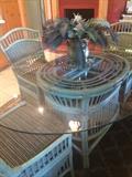 Glass top rattan table has 6 chairs