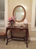 Antique writing table and oval mirror.