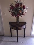 SMALL HALF MOON TABLE WITH BEAUTIFUL FAUX FLOWER ARRANGEMENT