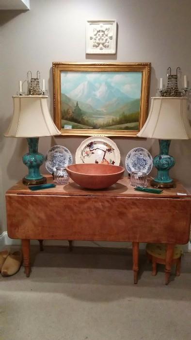 LOVE this antique heart pine, drop-leaf dining table, pair of vintage teal porcelain dragon lamps, large hand-turned pine bowl, vintage English charger, original, artist signed oil painting, on canvas, pair of crystal sconces from the old Biltmore Hotel, Polish lead crystal/silver plated jars, pine/embroidered footstool. 