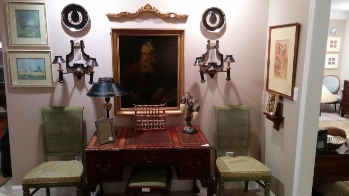 Antique original oil painting of a copy of Titian, sporadic collection of black tole/gold plates, table lamp, pair of Italian sconces, Art Deco 2-light desk lamp, pair of French green side chairs, GORGEOUS antique mahogany/leather insert desk, with ball & claw feet