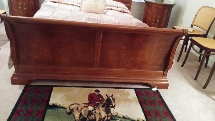 Footboard of the sleigh bed.                                               The rug seems to lend itself to horsing around.