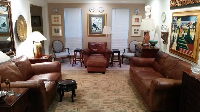 Wonderful living room, with loads of leather seating, hand woven 100% wool rug, GREAT art, smalls, etc. 