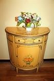Imperial Furniture Co. hand-painted demilune cabinet and Italian tole floral arrangement