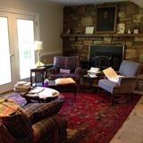 Spanish style bench, inlaid mahogany table, round tea table, small end table, soft blue and plum plaid chairs