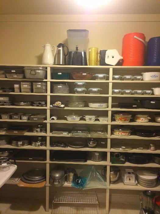 A pantry full of Pyrex, Tupperware, and other cookware
