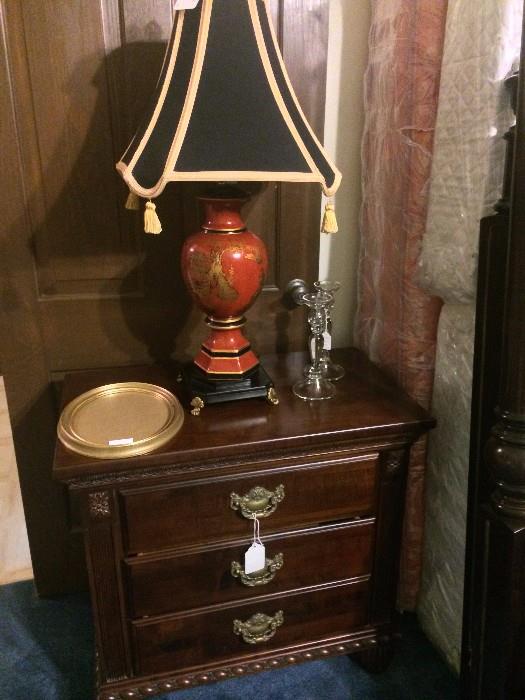 One of two three-drawer nightstands that match the king bed; one of two matching Asian lamps