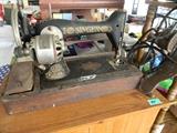 Antique Singer sewing machine with wooden case and foot pedal