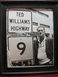 Ted Williams by the Ted Williams Highway 9 Sign in Massachusetts. There was another photo released similar to this by the AP, this is the only known of this photograph.