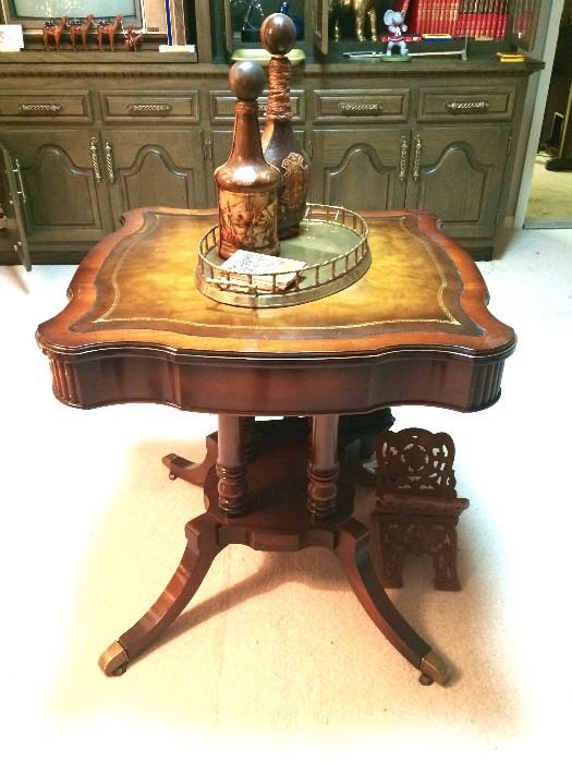 Lovely leather-top antique table featuring leather decanters on brass tray